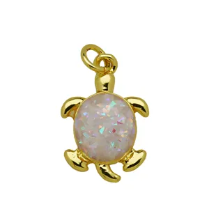 Gold turtle pendant necklace with opal crushed stone shell detail, stylish jewelry accessory.
