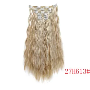 Detailed view of clip-in hair extensions, wavy blonde highlighted long hair with clips.