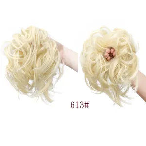 Closeup of fluffy blonde synthetic hair bun extension, messy curly scrunchie hairpiece.