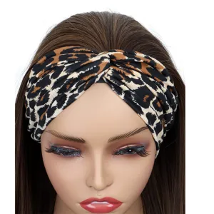 Detailed close-up of the leopard print twist headband, showing soft fabric texture and knot.