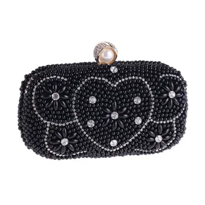 Black beaded evening clutch bag with sparkling rhinestones, elegant heart and floral pattern.