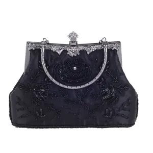 Vintage black beaded evening bag with exquisite embroidery, metal frame and clasp for formal events.