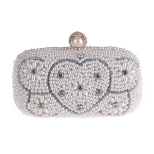 Elegant pearl clutch bag with sparkling rhinestones and heart design for evening parties.