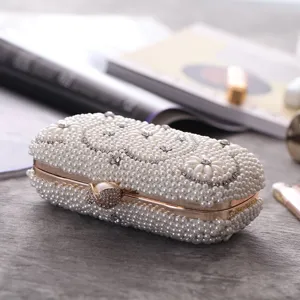 Pearl evening clutch bag with rhinestone and gold metal frame for wedding party dress.