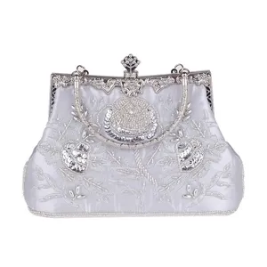 Detailed view of vintage silver evening bag with delicate bead and sequin floral embroidery.