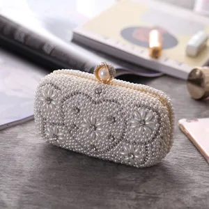 Pearl evening clutch bag with rhinestones and heart design, elegant detail view for party.