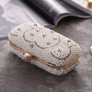 Elegant pearl evening clutch bag with sparkling rhinestones and gold hardware for weddings.