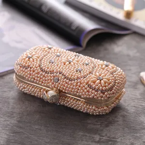 Pearl evening clutch bag with rhinestones, elegant handmade metal frame accessory for parties.