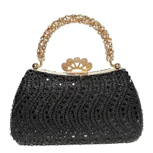 Detailed view of the sparkling black rhinestone evening clutch bag with gold handle and clasp.