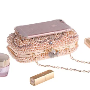 Exquisite pearl evening clutch bag with sparkling rhinestones and metal chain details.