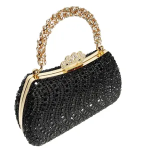 Detailed close-up of a sparkling black rhinestone evening clutch with gold metal frame and handle.