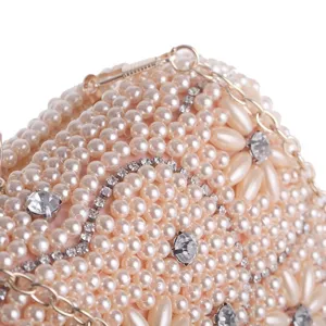 Pearl rhinestone evening clutch bag detail shot showing exquisite beaded craft and metal chain.