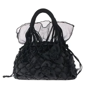 Black handmade woven net handbag with sheer floral ruffle design, elegant evening party bag.