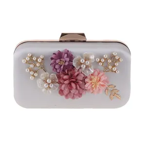 Exquisite floral evening clutch bag with pearls and metallic clasp for elegant parties.