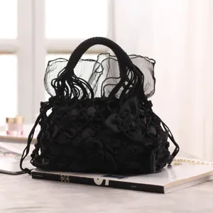 Black handmade mesh handbag with elegant fabric roses and sheer tulle ruffles for evening parties.