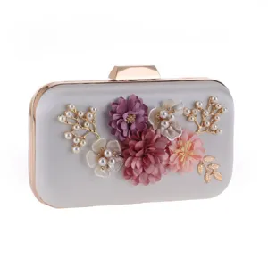 Elegant silver evening clutch bag with stunning floral pearl details for formal parties.
