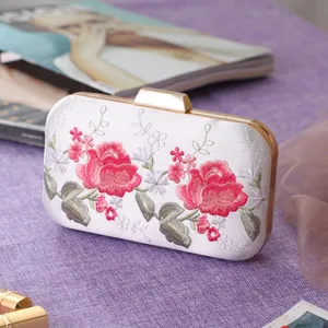 Elegant embroidered satin evening clutch bag with delicate pink roses and gold hardware detail.