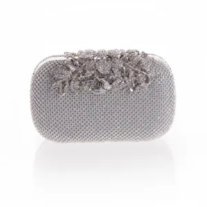 Detailed view of silver rhinestone evening clutch bag, elegant crystal floral clasp design.