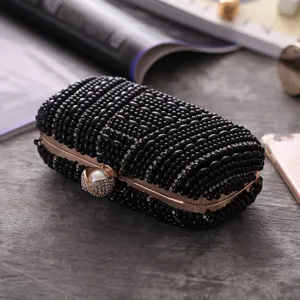 Elegant black beaded evening clutch bag with rhinestones and metal frame for women events.