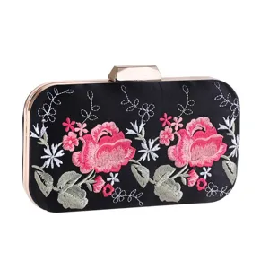 Detailed view of the black satin evening clutch featuring exquisite pink embroidered roses and gold frame.