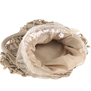 Detailed view of champagne handmade woven net evening bag with satin inner pouch and mesh ruffle.