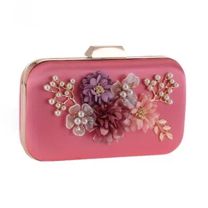 Elegant pink satin evening clutch with floral pearl decor, perfect for weddings and parties.