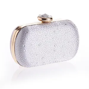 Detailed view of the silver rhinestone evening clutch with gold metal frame and crystal clasp.