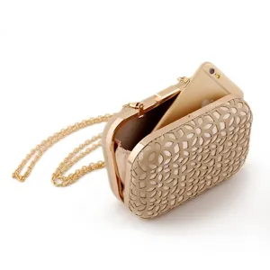 Elegant PU evening clutch bag with metallic chain and stylish hollow design for party.