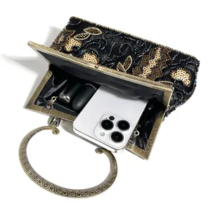 Vintage beaded evening clutch bag with metal kiss-lock handle, detail view showing capacity.
