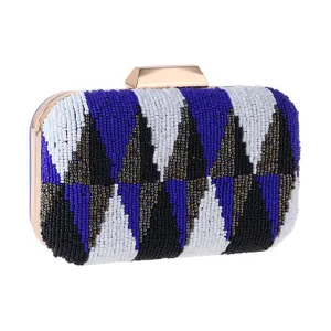 Beaded evening clutch bag detail showing intricate blue and white geometric beadwork patterns.