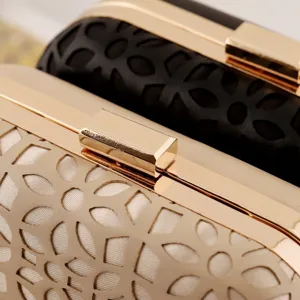 Detailed shot of women evening clutch bag PU leather metallic clasp hollow out floral pattern texture