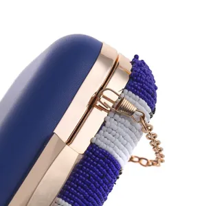 Elegant beaded evening clutch bag with blue PU leather and gold chain detail for women.