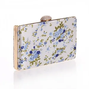 Blue and white floral print hard clutch bag with rhinestone clasp and gold frame for evening parties.