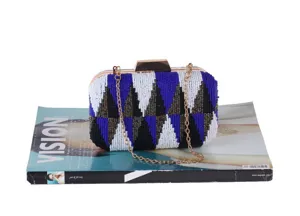Beaded clutch bag detail view, elegant evening bag with geometric pattern and metal chain.