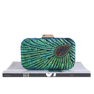 Exquisite sequin beaded clutch bag with peacock feather design and metal clasp for evening.