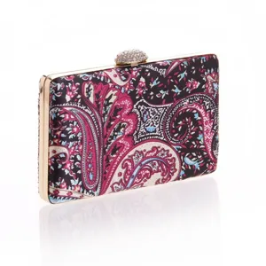 Detailed view of the luxury paisley print evening clutch bag with sparkling crystal jeweled clasp.