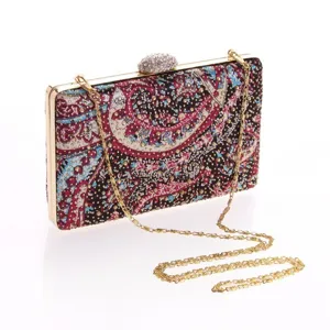 Elegant rhinestone embellished evening clutch with vintage paisley print and gold chain strap.