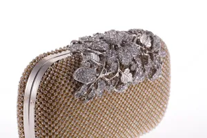 Luxurious crystal embellished evening clutch bag featuring intricate silver floral top detail.