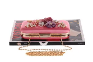 Pink satin evening clutch bag with floral pearl decor and metal chain strap for women.