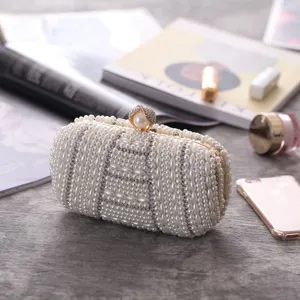 Exquisite handmade pearl rhinestone evening clutch bag with elegant metal clasp detail.