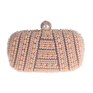 Handmade pearl rhinestone evening clutch bag detail view, elegant beaded bridal handbag closeup.