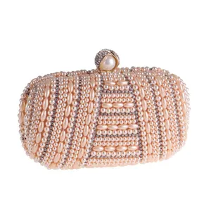 Elegant handmade pearl evening clutch bag with sparkling rhinestones for women parties.