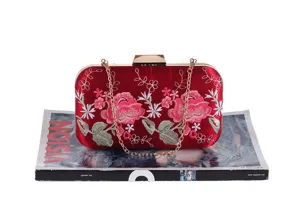 Red velvet evening clutch bag with exquisite floral embroidery and a golden chain strap.