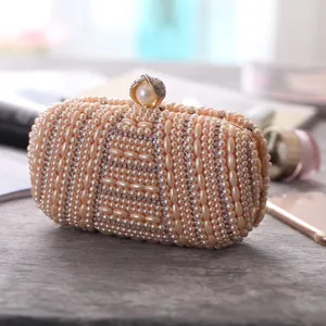 Elegant handmade pearl evening clutch bag with sparkling rhinestones for women parties.