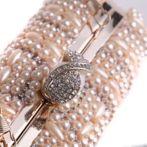 Handmade beaded evening clutch bag detail, exquisite pearls and rhinestones decoration.