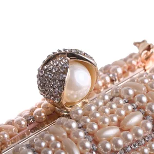 Handmade pearl rhinestone evening clutch bag detail, luxury bridal wedding purse.