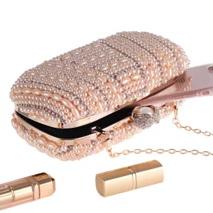 Pearl beaded evening clutch bag detail showing exquisite handmade craftsmanship and chain strap.