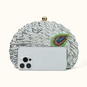 Elegant beaded sequin clutch bag with peacock feather design and gold clasp for evening parties.