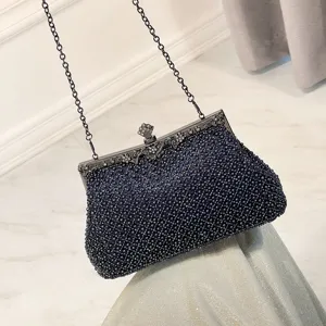 Elegant beaded evening clutch bag with metallic chain, perfect for parties and formal dress styling.