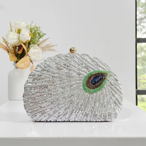 Exquisite beaded evening clutch bag detail showing intricate sequin peacock embroidery craftsmanship.
